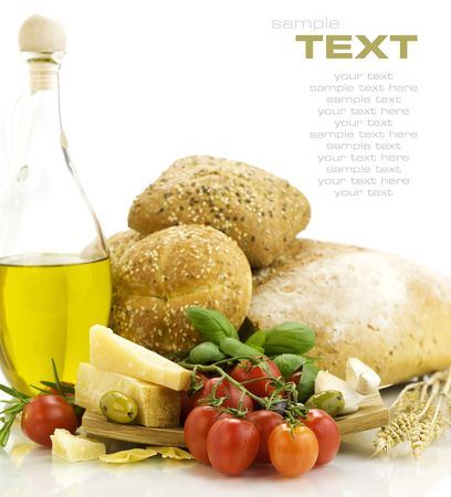 Fresh ingredients for an Italian dinner and appetizers over white. With sample textの写真素材
