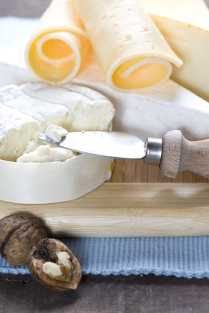 Cheese still life on a wooden board