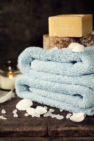 Seashells, candle, soaps and blue towelsの写真素材