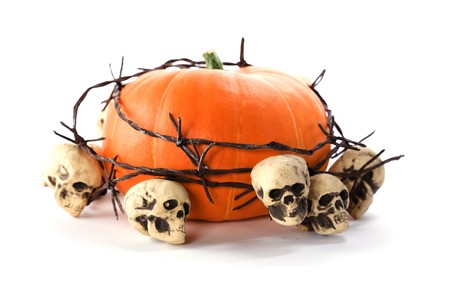 Pumpkin and skulls over whiteの写真素材