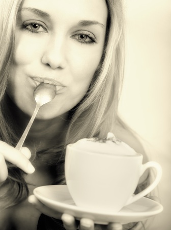 Beautiful woman holding cup of coffee and smilingの写真素材