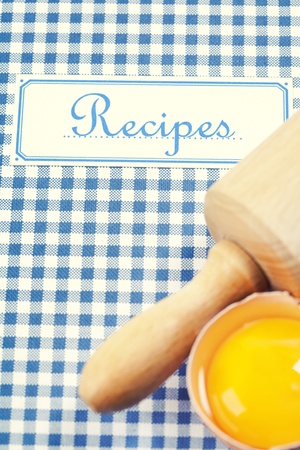 The book of recipes with egg and rolling pinの写真素材