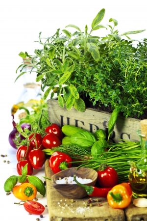 herbs in the box and fresh vegetables over whiteの写真素材