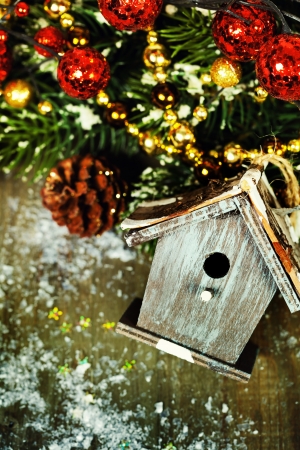Bright christmas composition with small birdhouseの写真素材
