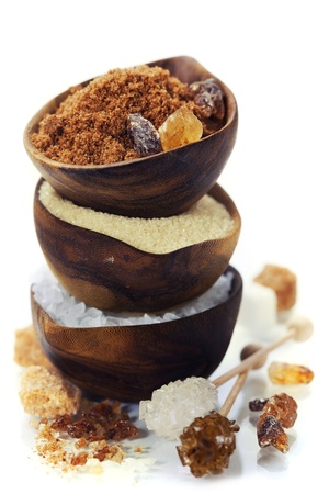 Various kinds of sugar in wooden bowlsの写真素材