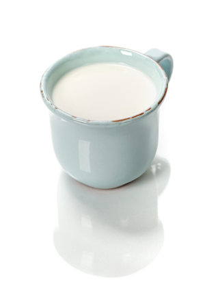 cup of milk over whiteの写真素材