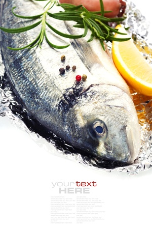 fresh dorada fish with thyme and lemon over white - food and drink border (with easy removable sample text)の写真素材