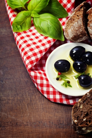 Olives and Olive Oil on an old tablelの写真素材