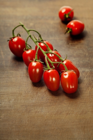 fresh tomatoes  on the wooden backgroundの写真素材