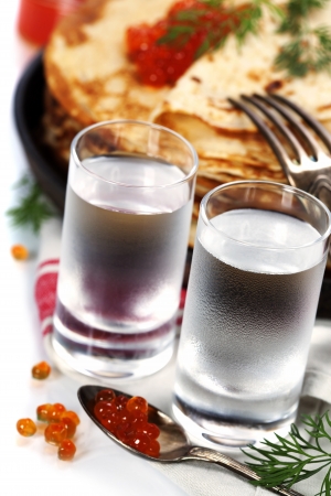 Russian vodka with pancakes and red caviar on white backgroundの写真素材