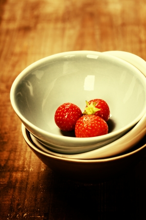 Strawberries in a Bowl on wooden backgroundの写真素材