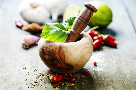 Red Hot Chili Peppers, herbs and spices with Mortar and Pestle over wooden backgroundの写真素材