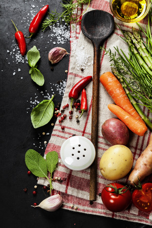 Wooden spoon and ingredients on dark background.の写真素材