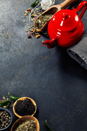 Tea composition with red teapot on dark backgroundの写真素材