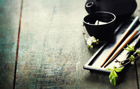 Chinese Tea Set,chopsticks and sakura branch on rustic wooden tableの写真素材