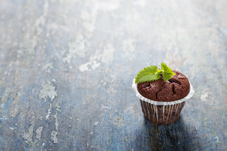 Chocolate muffins on wooden board - food and drinkの写真素材