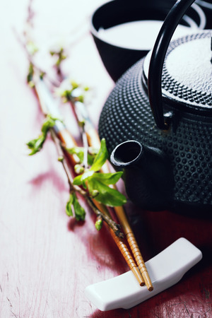 Chinese Tea Set,chopsticks and sakura branch on rustic wooden tableの写真素材