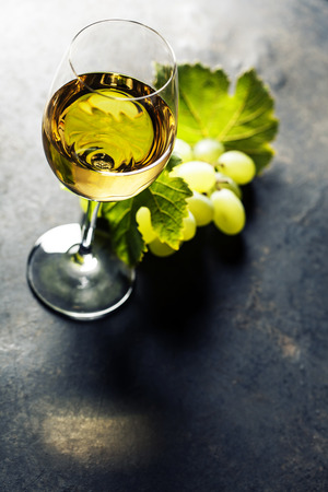 Glass of white wine on dark backgroundの写真素材