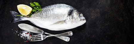 Delicious fresh fish on dark vintage backgroundの写真素材