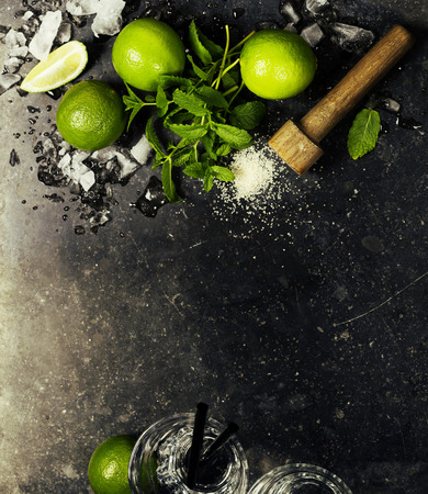 Ingredients for making mojitos (ice cubes, mint leaves, sugar and lime on rustic background)の写真素材