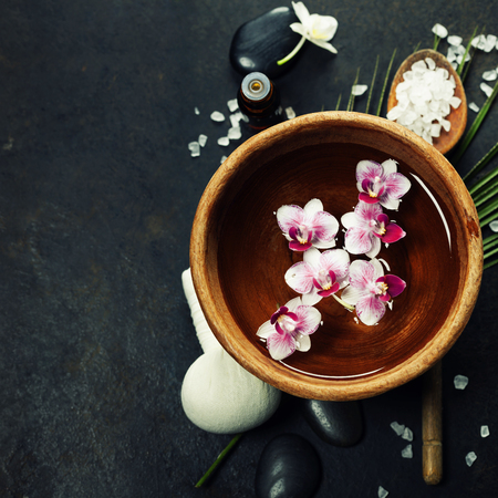 Close up of flowers floating in bowl of water and SPA settingの写真素材