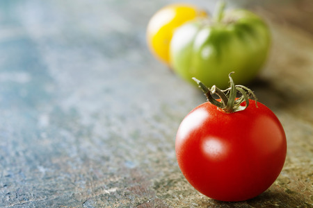various of colorful tomatoes on wooden backgroundの写真素材