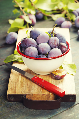 Sweet plums on wooden background.Bio healthy fruits. Selective focus. Copy space backgroundの写真素材