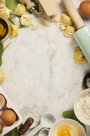 Top view on homemade pasta ravioli on old  table with ingredients and vintage kitchen accessoriesの写真素材