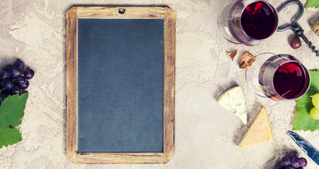 Wine appetizers set: French cheese selection, grapes and walnuts on rustic background. Top view, copyspaceの写真素材