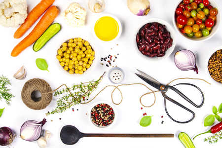 Colorful food ingredients on white background. Bio Healthy food herbs and spices for health cooking. Organic cooking ingredients over white. Diet or vegetarian food concept. Top view copy space.の写真素材