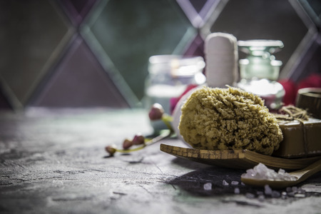 Spa concept with sea salt, massage herbal balls, candles and essencial oils on old stone background. Natural cosmetics and wellness conceptSpa. Spa treatment.の写真素材