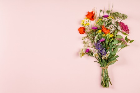 Wild flower bouquet on pastel color background. Top view, flat layの写真素材