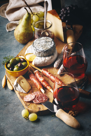 Red wine with charcuterie assortment on the stone backgroundの写真素材