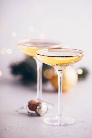 Two champagne glasses, cork and Christmas decorationsの写真素材