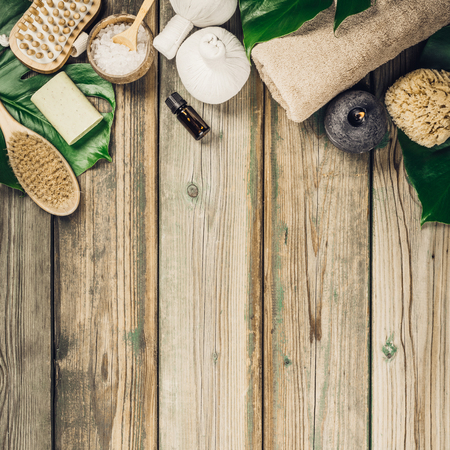 flat lay layout with monstera leaves and cosmetic care productsの写真素材