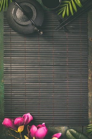 Asian food background, tea and chopsticks on dark background.の写真素材