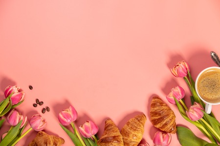 Morning coffee, croissants and a beautiful flowers on pinkの写真素材