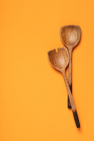 Wooden serving spoons on colorful background, flat lay. Healthy eating or cooking conceptの写真素材