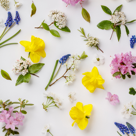 Floral pattern with spring flowers and leaves on white background. Flat lay composition for entrepreneurs, bloggers, magazines,の写真素材