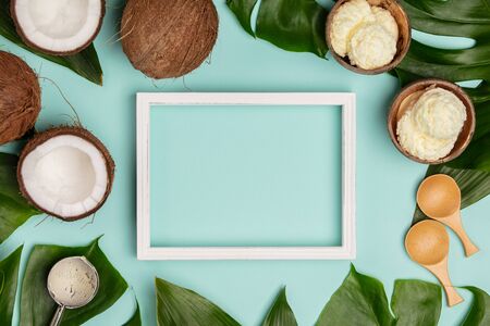 Creative flat lay with coconut ice cream and tropical plantsの写真素材