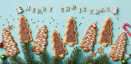 Merry Christmas written with wooden letters, cookies and Christmas decorations