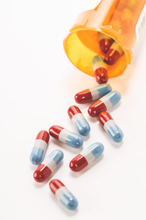 Assorted pharmaceutical medicine pills, tablets and capsules over white