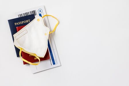 Coronavirus and travel concept. Passports, airplane tickets and medical mask flat lay.の写真素材
