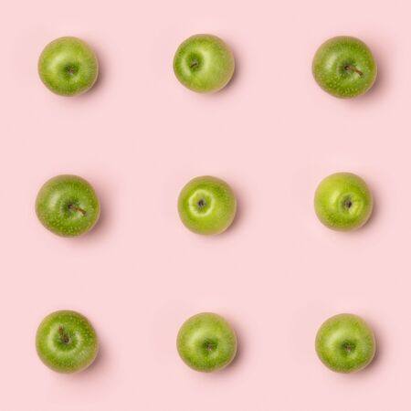 Apples pattern on pink background. Creative food concept. Flat laの写真素材