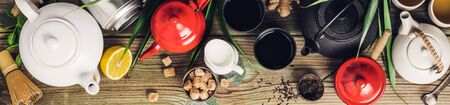 Various tea and teapots composition, dried herbal, green, black tea and matcha tea on wooden table background, flat lay, copy spaceの写真素材