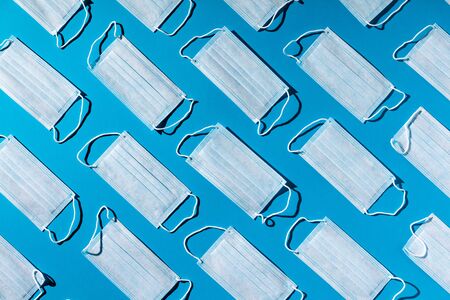 Medical masks on blue background.  Top view, Flat layの写真素材