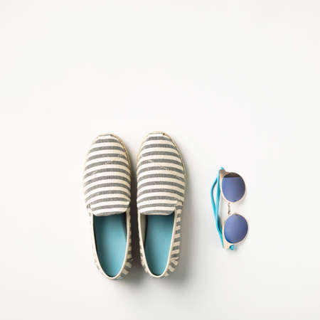 Summer vacation concept flat lay. Summer shoes and sunglasses, top view.の写真素材