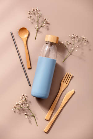 Zero waste, eco friendly concept. Reusable glass bottle and bamboo cutlery.の写真素材