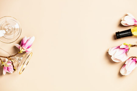 Spring magnolia flowers, bottle of wine and wine glasses flat lay, top view, copy spaceの写真素材