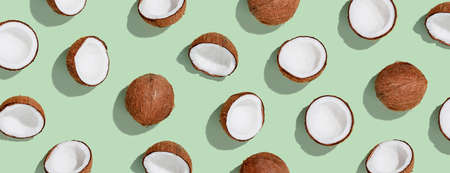 Pattern with ripe coconuts on green background. Top Viewの写真素材